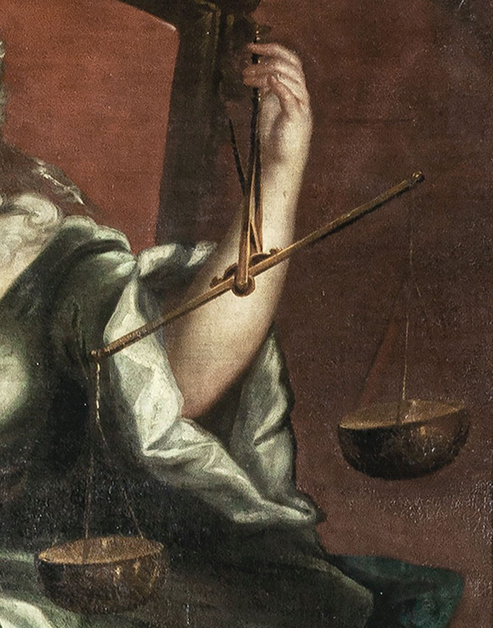 Fragment obrazu z dłonią trzymającą wagę